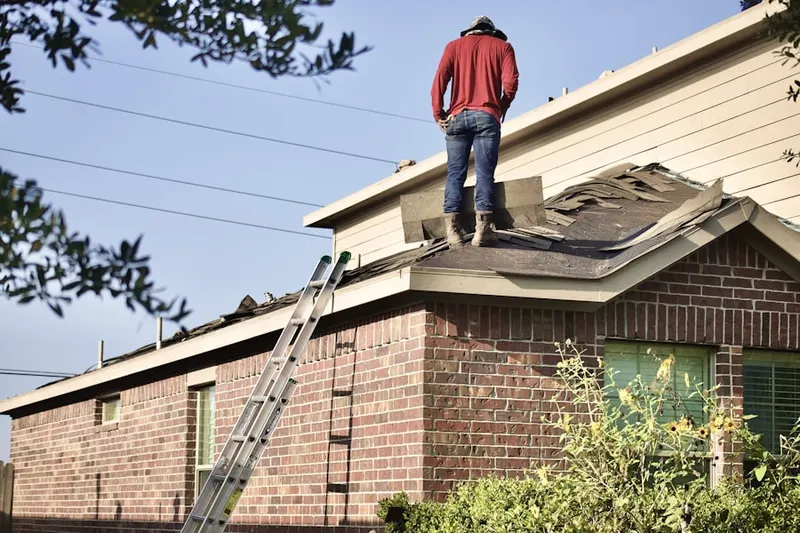 Professional roofer working on a residential roof in Moorlands